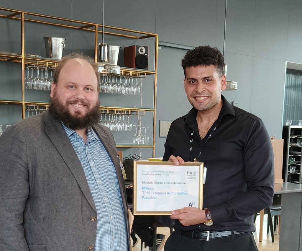 The poster award winner Mostafa Ghozal standing next to Lachlan Gunn, the host of the event.